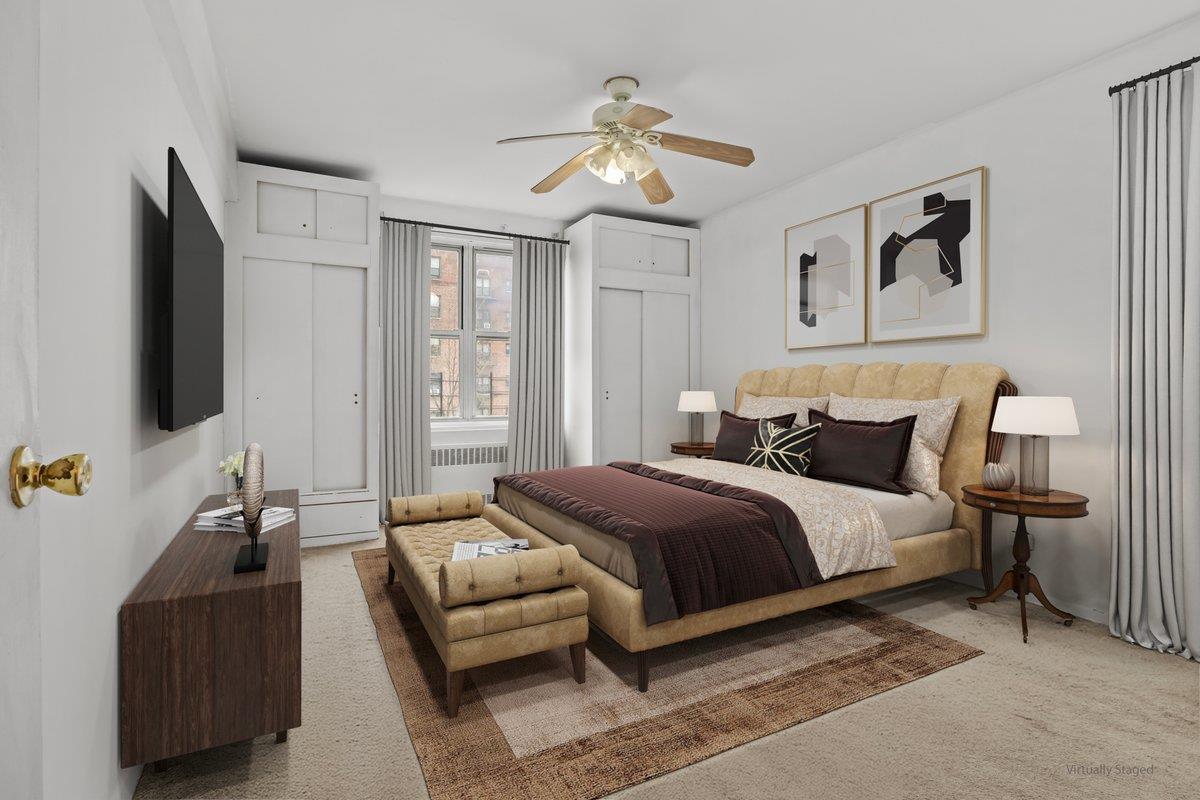 5601 Riverdale Avenue, Unit 5F Bronx, NY 10471 - Photo 16 of 25 a spacious bedroom with a bed and a flat screen tv