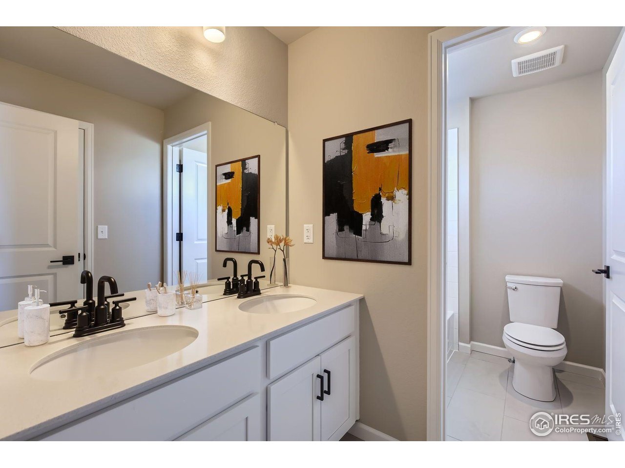 2344 Walbridge Road Fort Collins, CO 80524 - Photo 15 of 22 a bathroom with a double vanity sink and a mirror
