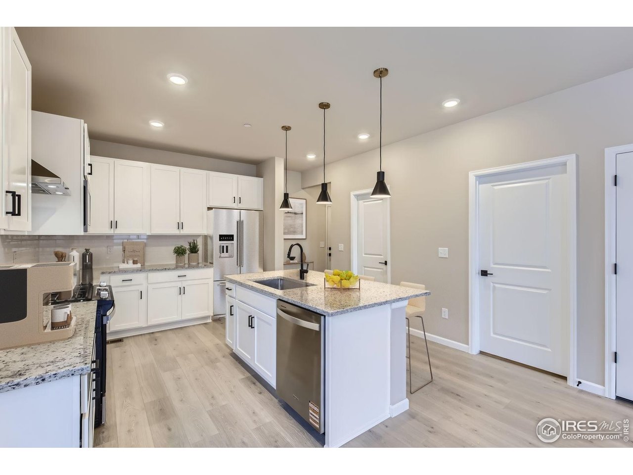 2344 Walbridge Road Fort Collins, CO 80524 - Photo 5 of 22 a kitchen with stainless steel appliances granite countertop a stove oven and white cabinets