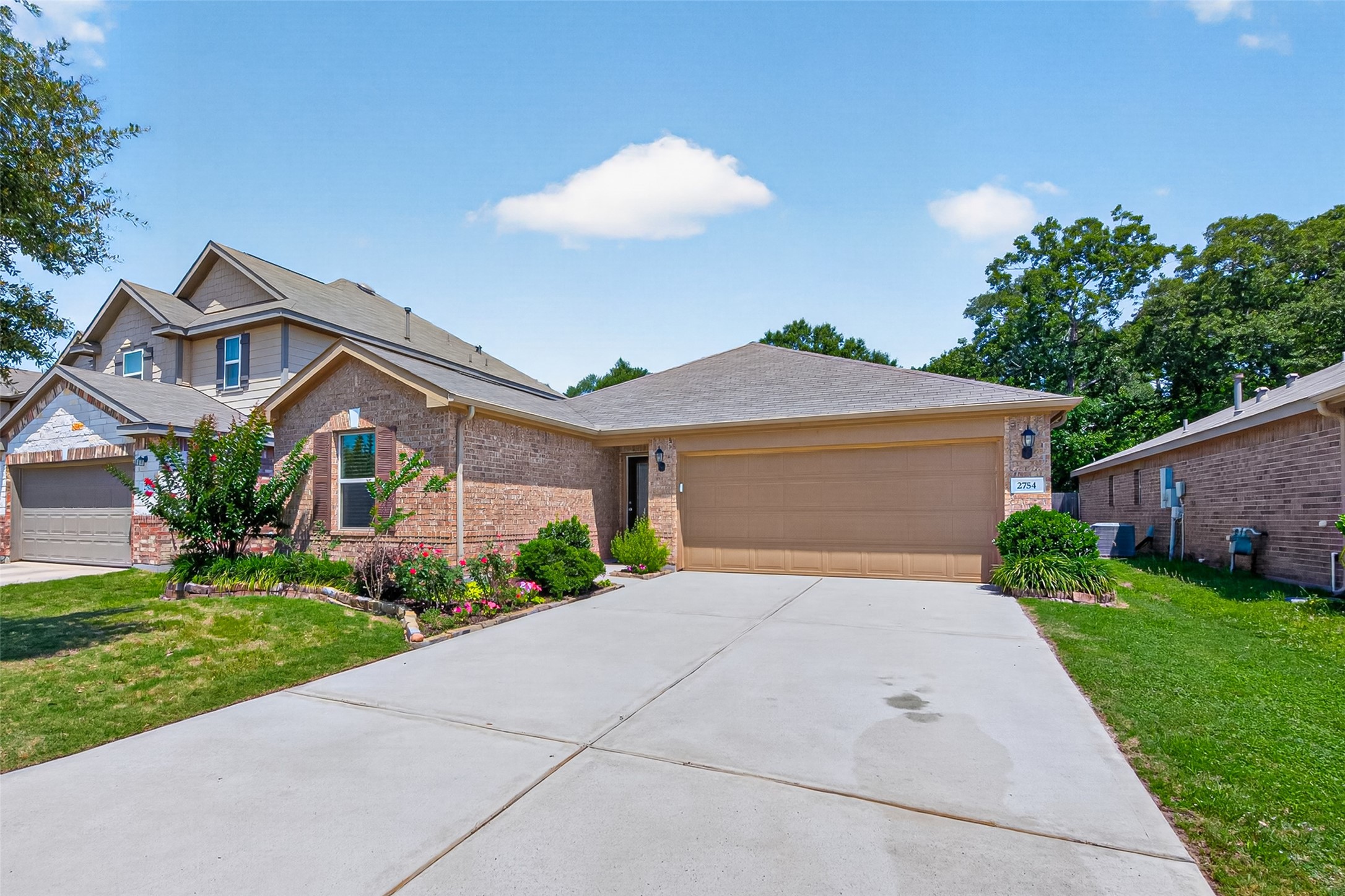 2754 Cayden Creek Way Conroe, TX 77304 - Photo 40 of 40 a front view of a house with a yard and garage