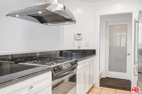 a kitchen with granite countertop a sink and a stove