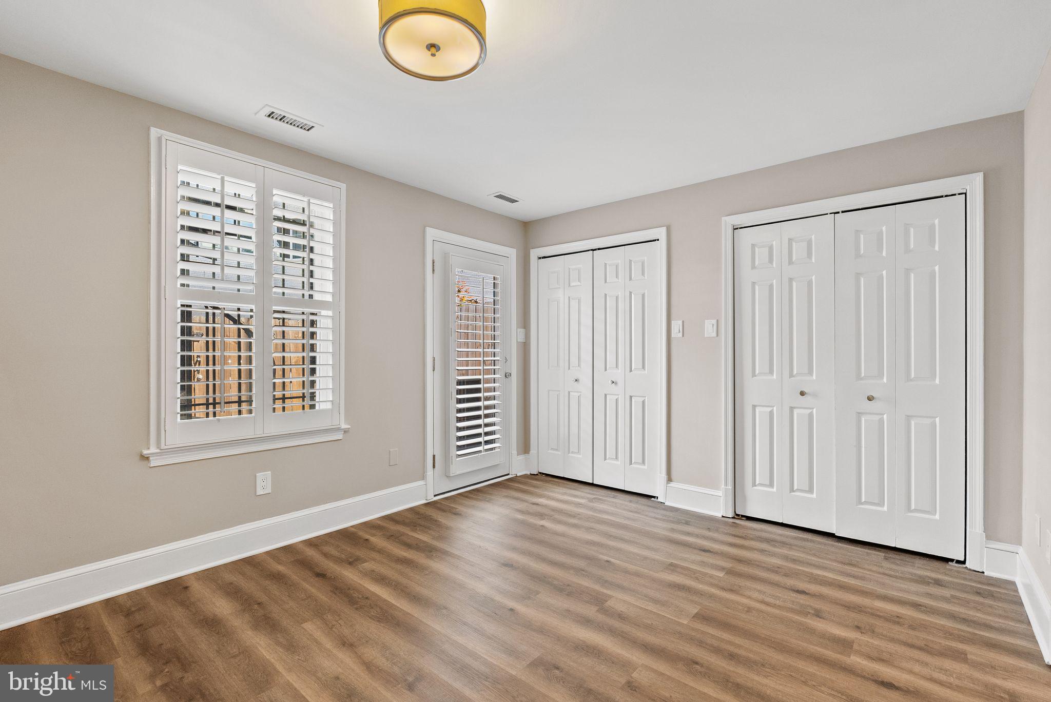 2011 Hillyer Place Northwest Washington, DC 20009 - Photo 17 of 21 a view of an empty room with wooden floor and a window