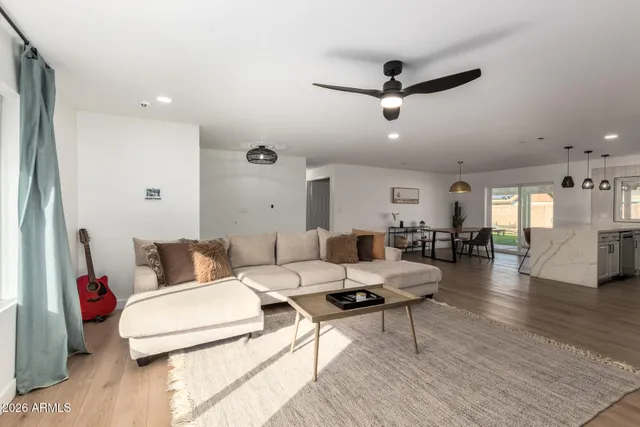 a living room with furniture and a wooden floor