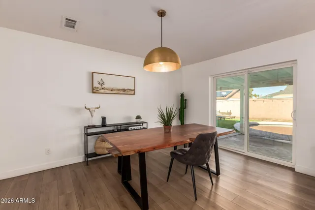 a view of a dining room with furniture window and wooden floor