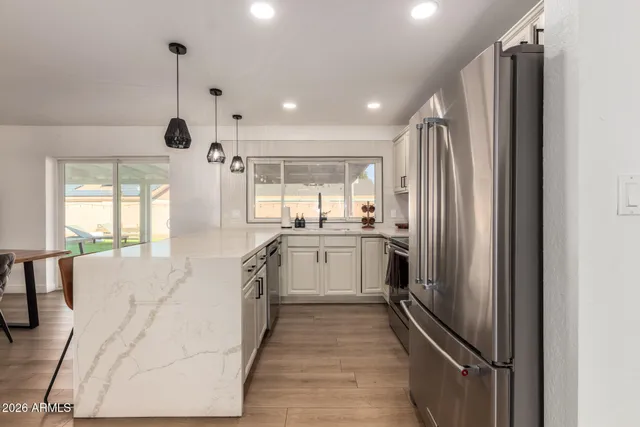a kitchen with a refrigerator and a sink