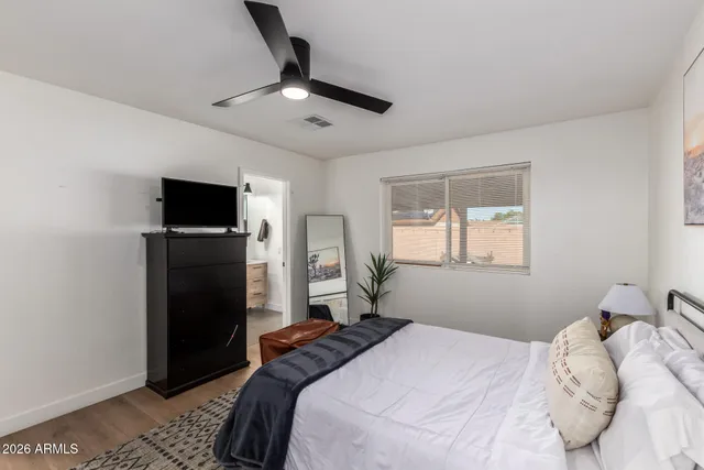 a bedroom with a bed and a television