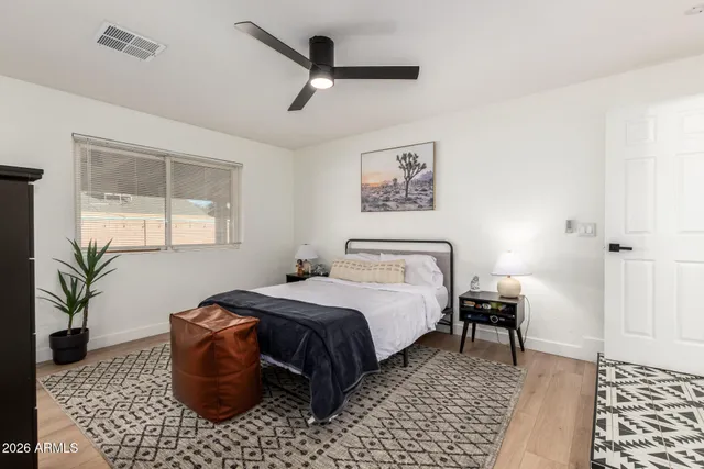 a bedroom with a bed and a table