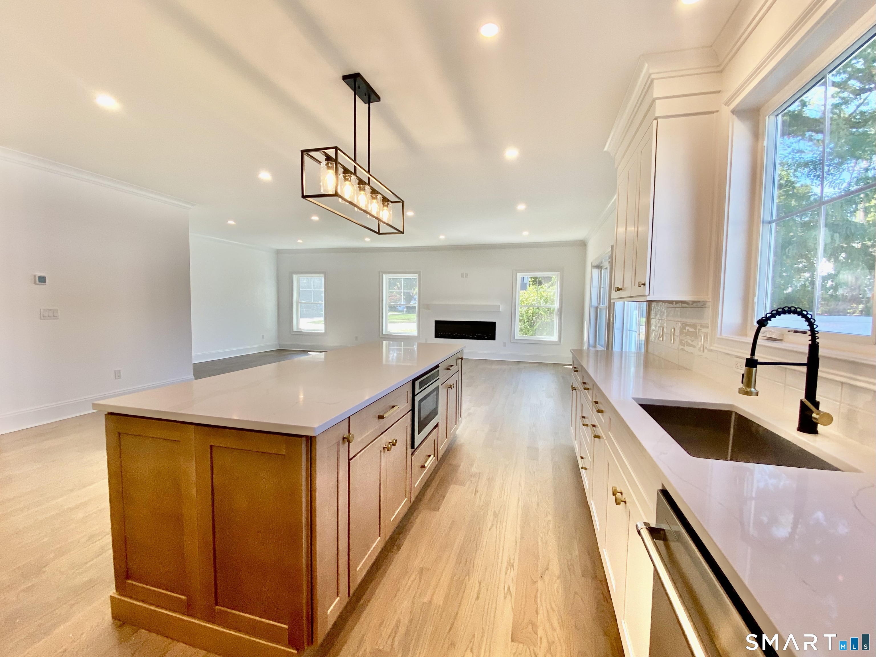 28 Country Road Fairfield, CT 06824 - Photo 2 of 14 Photos from similar contsruction from builder Open Kitchen, dining, expansive living room with fireplace.