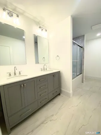 a spacious bathroom with a double vanity sink mirror and
