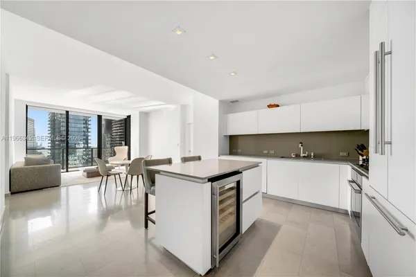 a kitchen with a table chairs stove and cabinets
