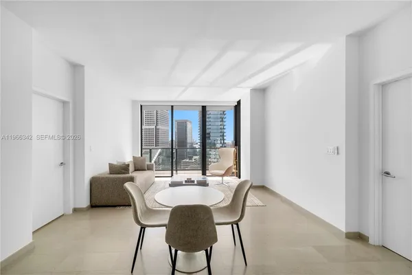 a dining room with furniture and window