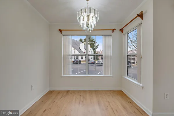a view of a kitchen with a sink and refrigerator