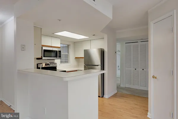 a kitchen with a sink stove and refrigerator
