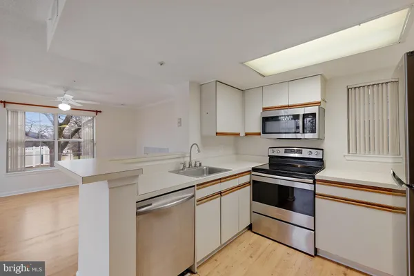 a kitchen with sink and refrigerator