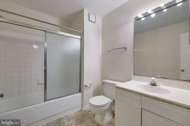 an empty room with a glass door and windows