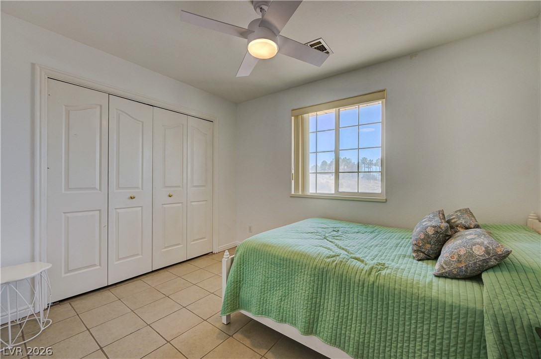 1272 Liston Avenue Logandale, NV 89021 - Photo 25 of 61 Ample closet space complements this cozy room, illuminated by natural light and overhead fan.