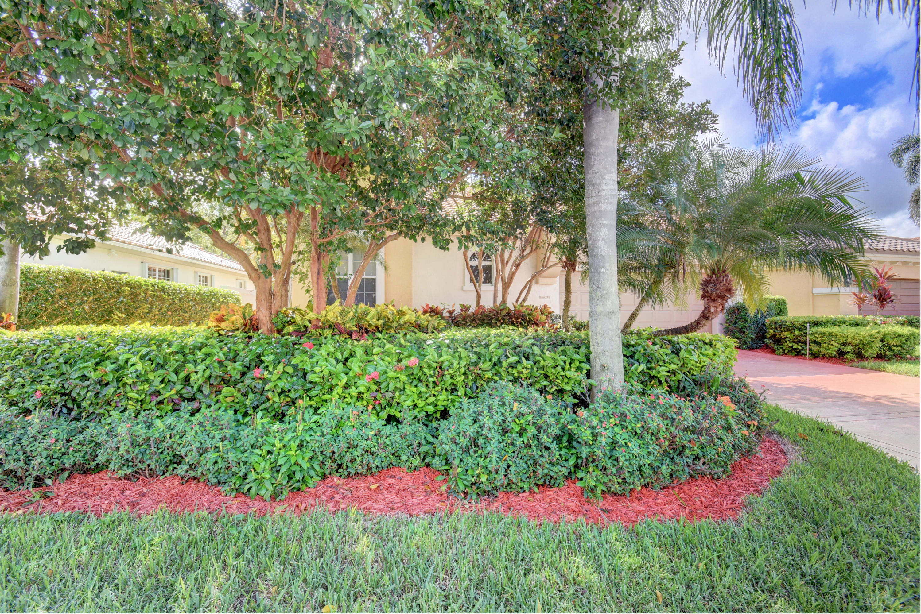 6286 Northwest 23rd Road Boca Raton, FL 33434 - Photo 3 of 44 a view of a garden with plants and large trees