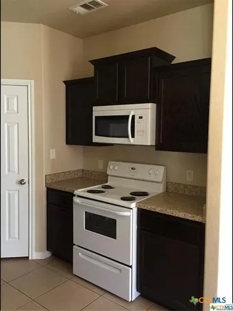 a kitchen with a stove and a microwave