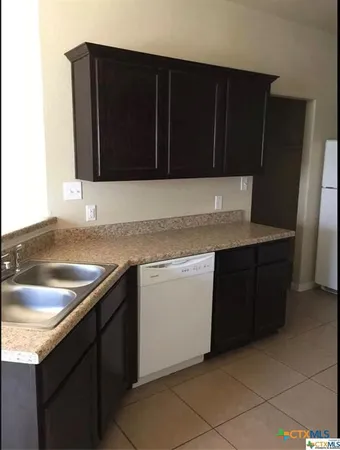 a kitchen with a sink and a microwave