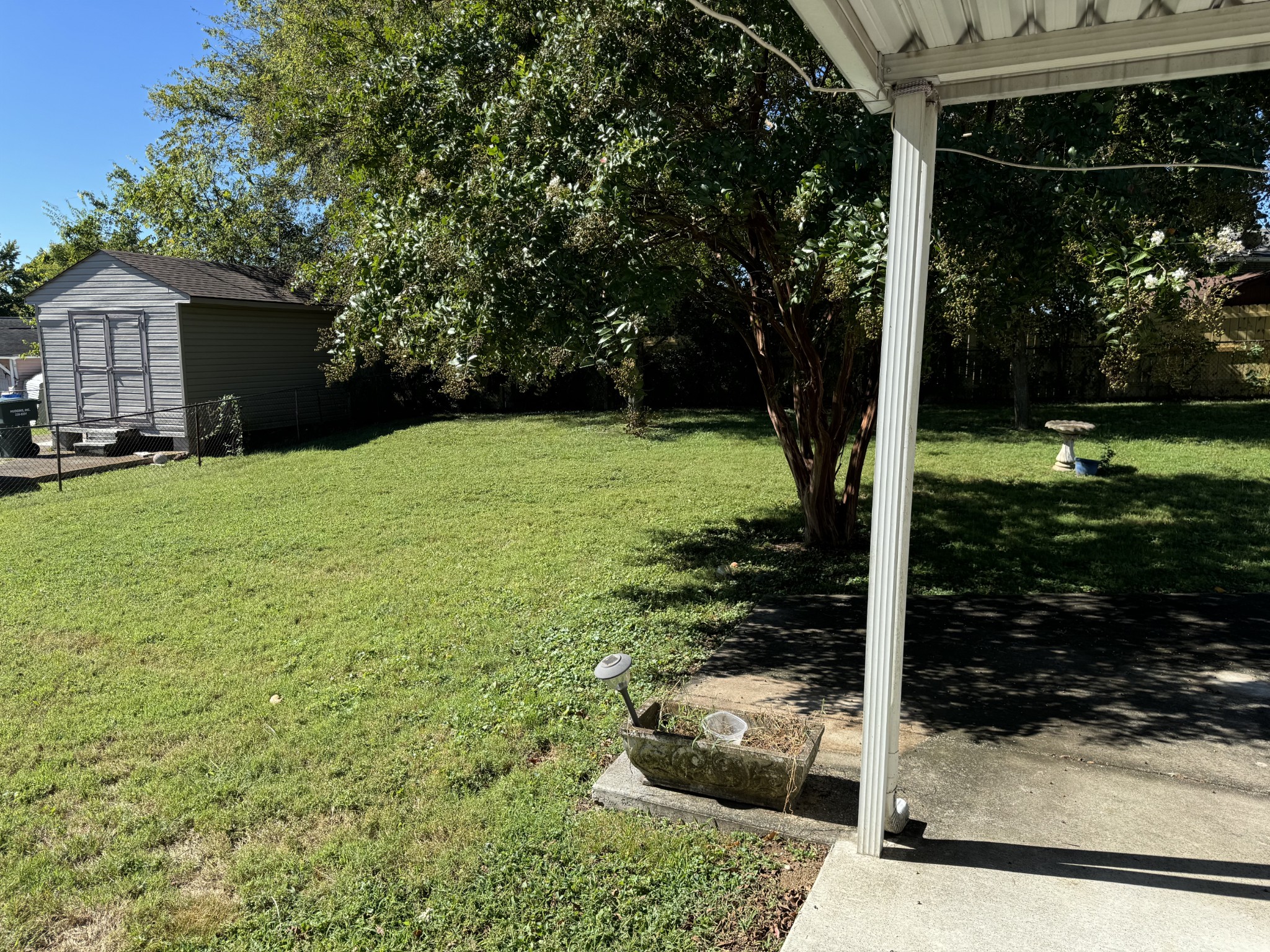 222 Bonnafield Drive Hermitage, TN 37076 - Photo 10 of 16 a backyard of a house with plants and large tree