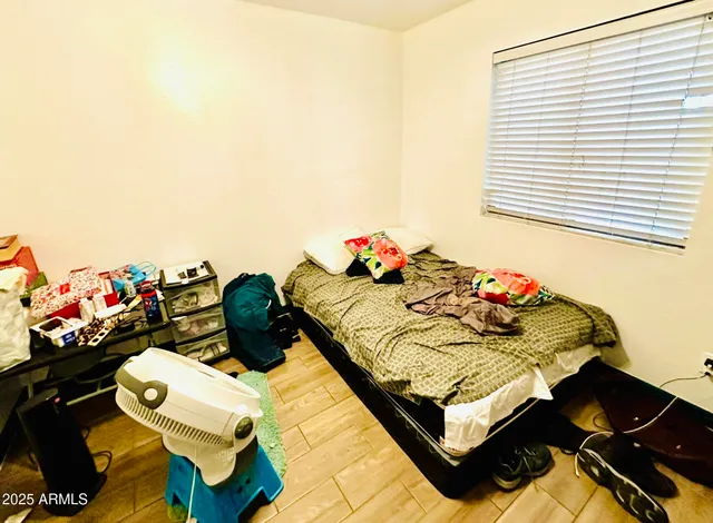 a bedroom with a bed and a chandelier