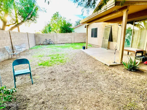 a view of a backyard with a sitting area
