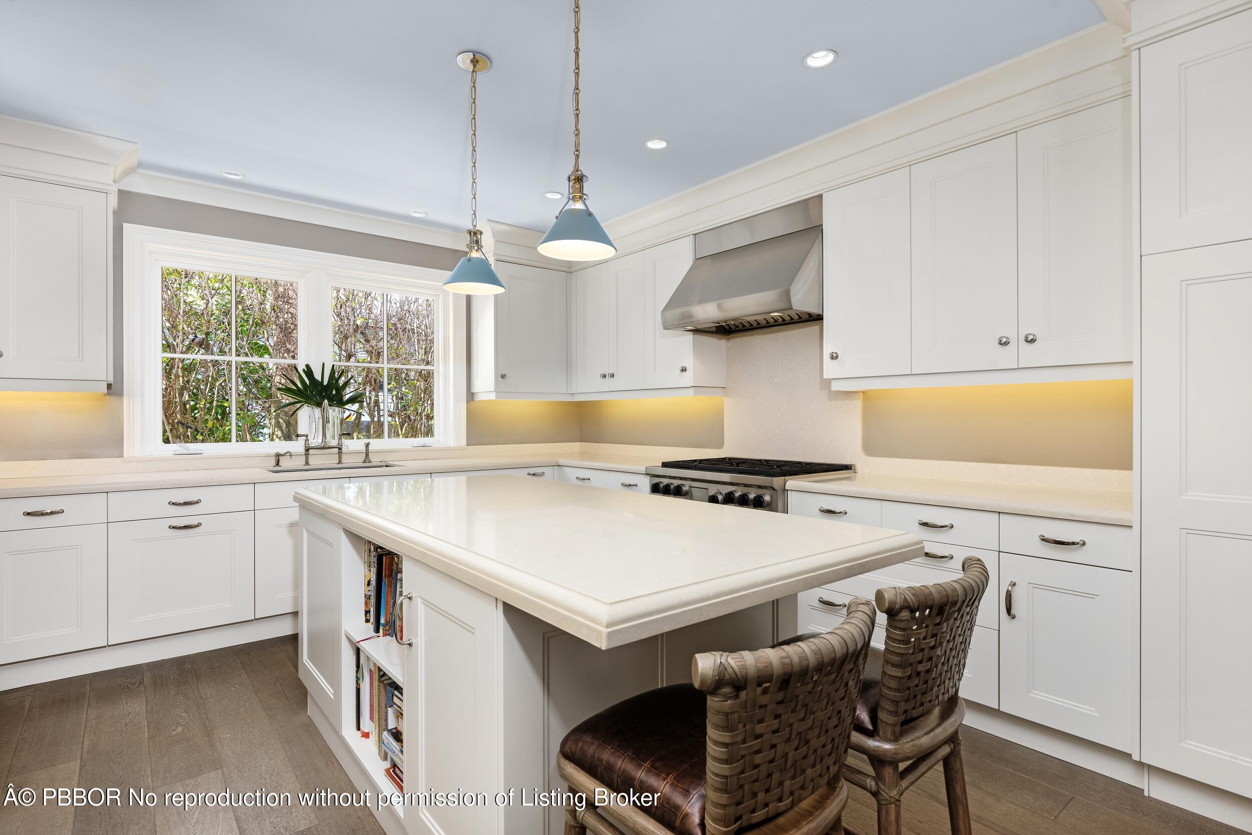 258 List Road Palm Beach, FL 33480 - Photo 14 of 45 a kitchen with a stove a sink a dining table and chairs