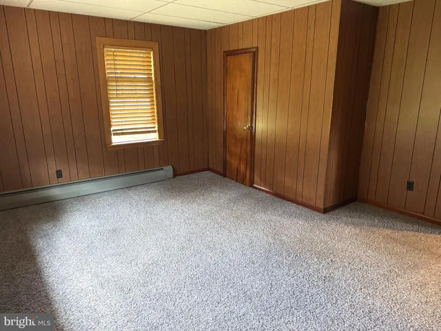 an empty room with a empty space and windows