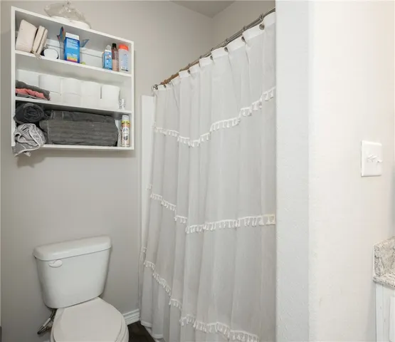 a white toilet sitting next to a bathroom sink