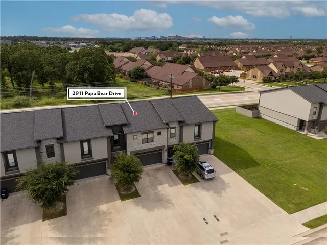 an aerial view of a house with garden space and lake view