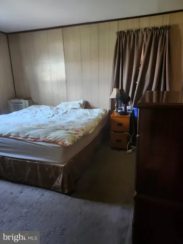 a bedroom with a bed and a mirror