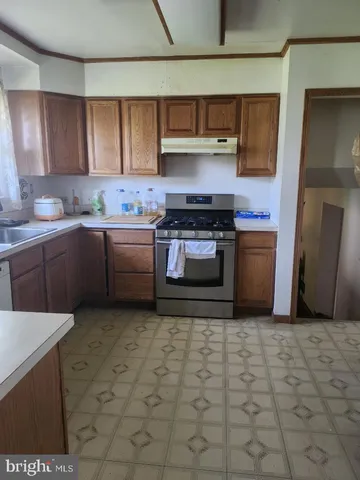 a kitchen with stainless steel appliances granite countertop a sink stove and cabinets