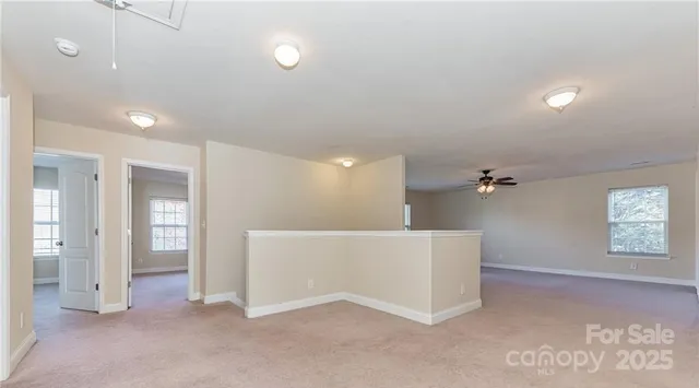 an empty room with windows and entrance