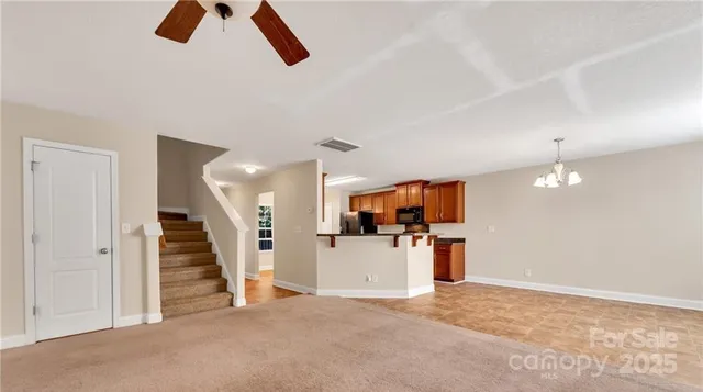 a view of a kitchen with furniture and a ceiling fan