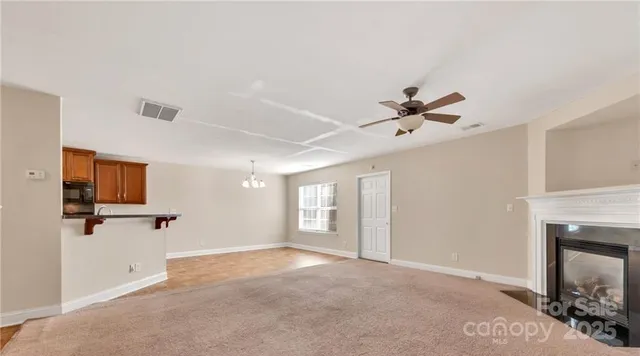 a view of a livingroom with a ceiling fan and window