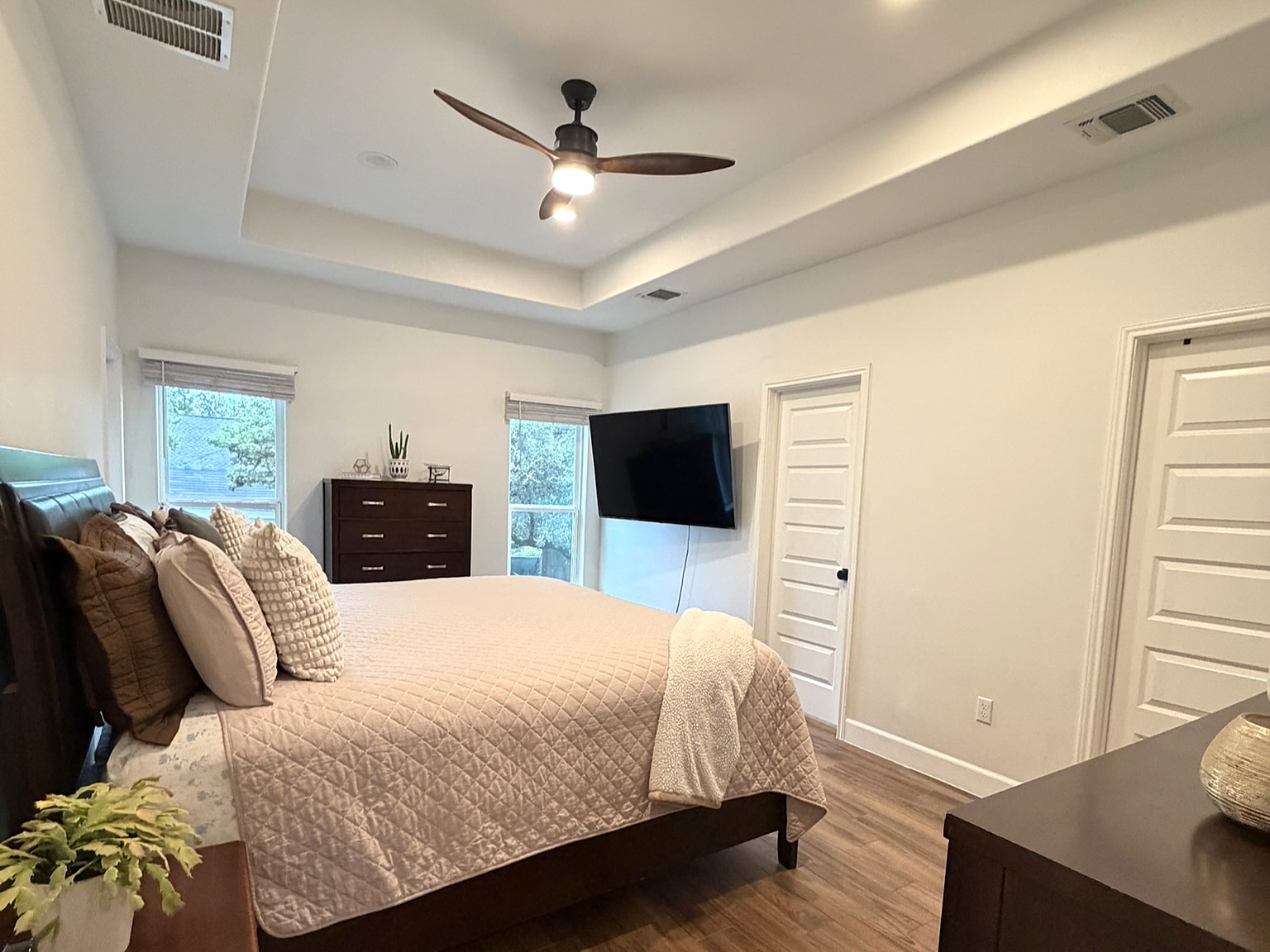 20602 Oak Ridge Lago Vista, TX 78645 - Photo 10 of 35 An elegant tray ceiling and rich wood floors anchor this restful bedroom space.