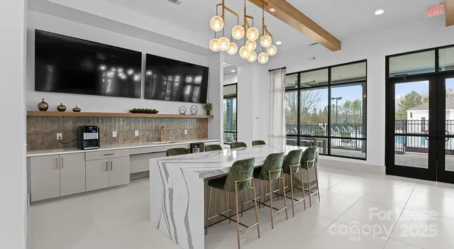 a large kitchen with a table and chairs