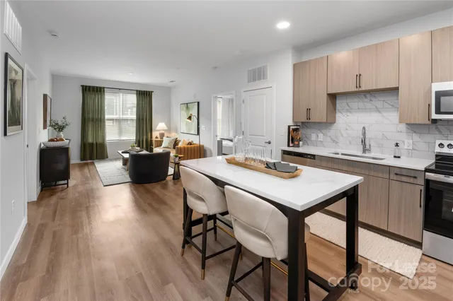 a kitchen with a table chairs sink and cabinets