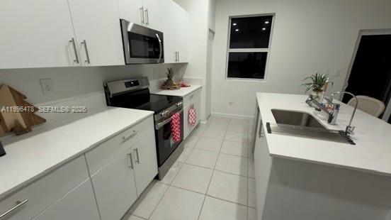 17854 Southwest 359 Terrace Homestead, FL 33034 - Photo 2 of 46 a kitchen with a sink and a stove top oven
