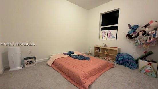 17854 Southwest 359 Terrace Homestead, FL 33034 - Photo 28 of 46 a bedroom with a bed a flat tv screen and a on desk