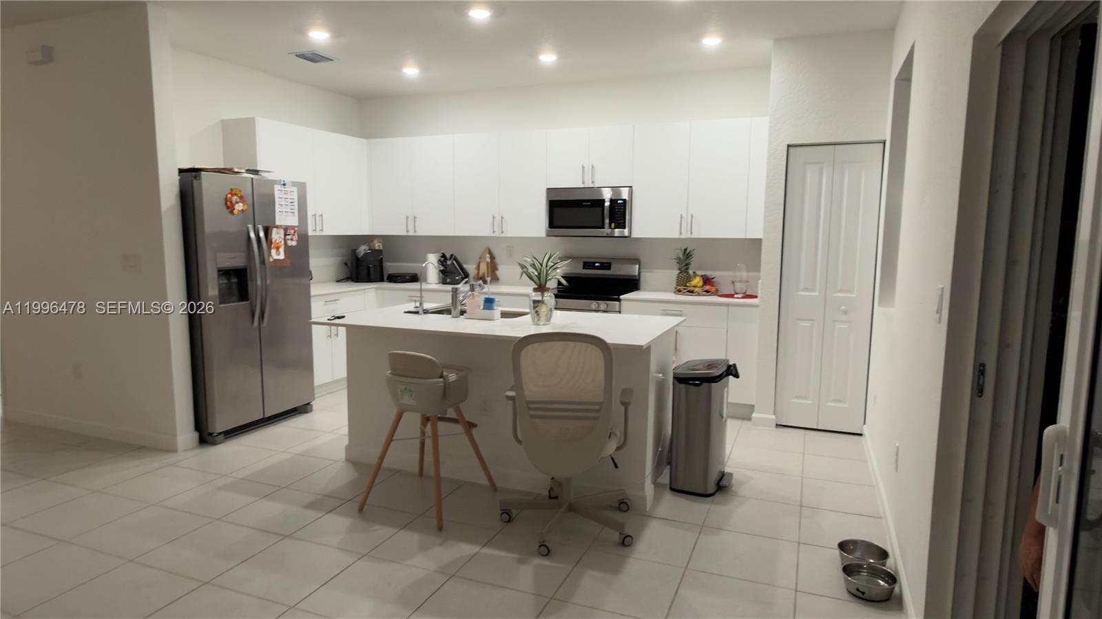 17854 Southwest 359 Terrace Homestead, FL 33034 - Photo 7 of 46 a dining room with stainless steel appliances a refrigerator and a refrigerator