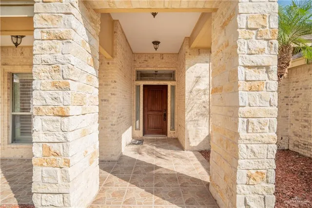 a front view of a building with a garden