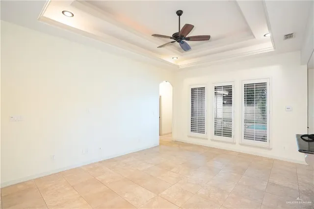 a view of a livingroom with a ceiling fan and window