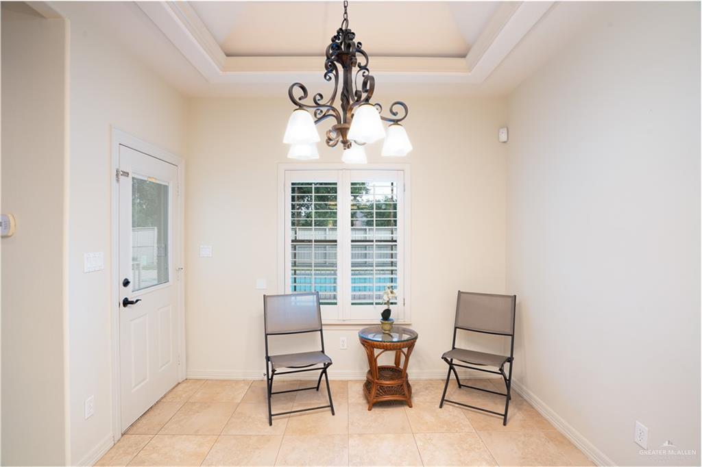 3305 Santa Monica Street Mission, TX 78572 - Photo 9 of 28 a dining room with wooden floor and a chandelier