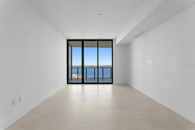 a patio with patio a table and chairs and potted plants