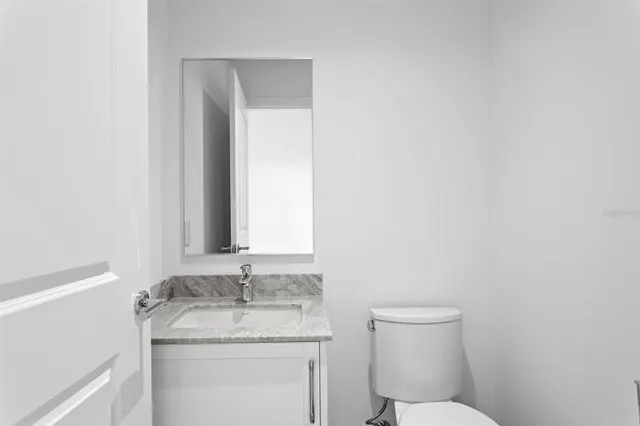 a living room with furniture and painting on the wall