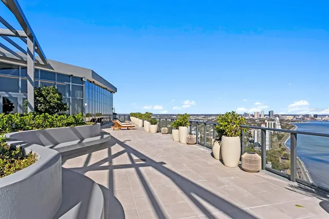 a living room with furniture a flat screen tv and a wall painting