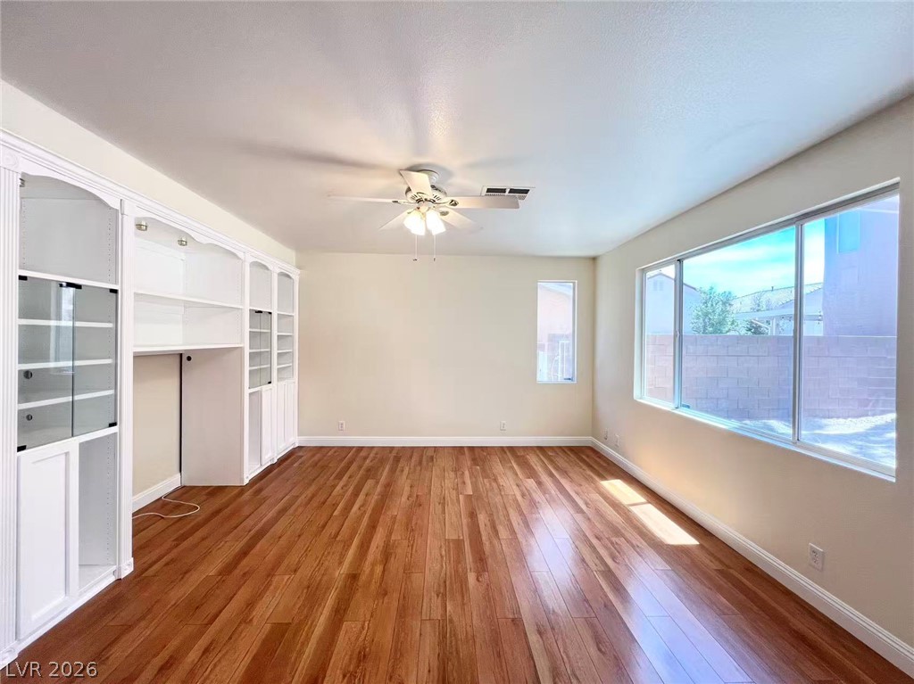 9891 Ridge Hill Avenue Las Vegas, NV 89147 - Photo 7 of 29 Built-in shelving and ample natural light define this versatile space.