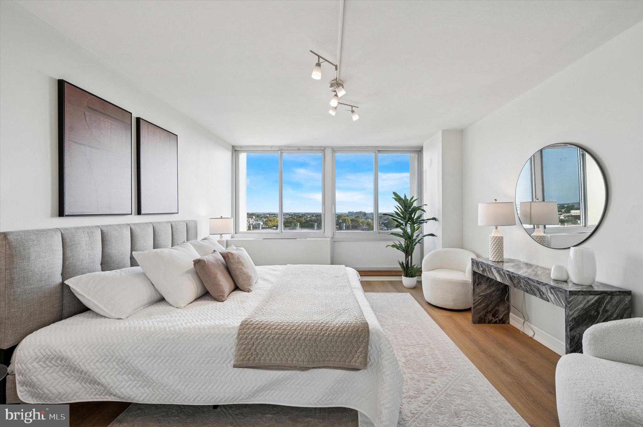 604 South Washington Square, Unit 1015 Philadelphia, PA 19106 - Photo 12 of 24 a large bedroom with a large bed and windows