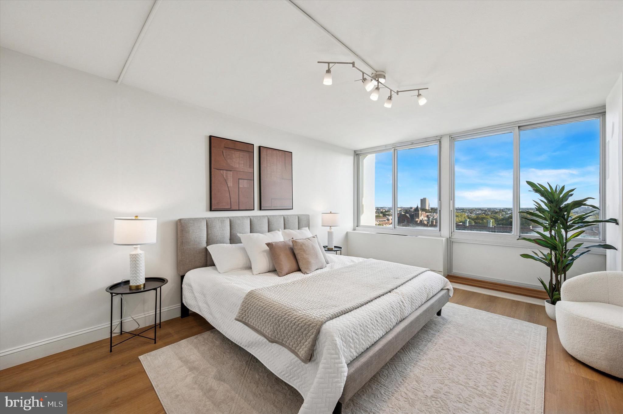 604 South Washington Square, Unit 1015 Philadelphia, PA 19106 - Photo 13 of 24 a bedroom with a large bed and a chandelier